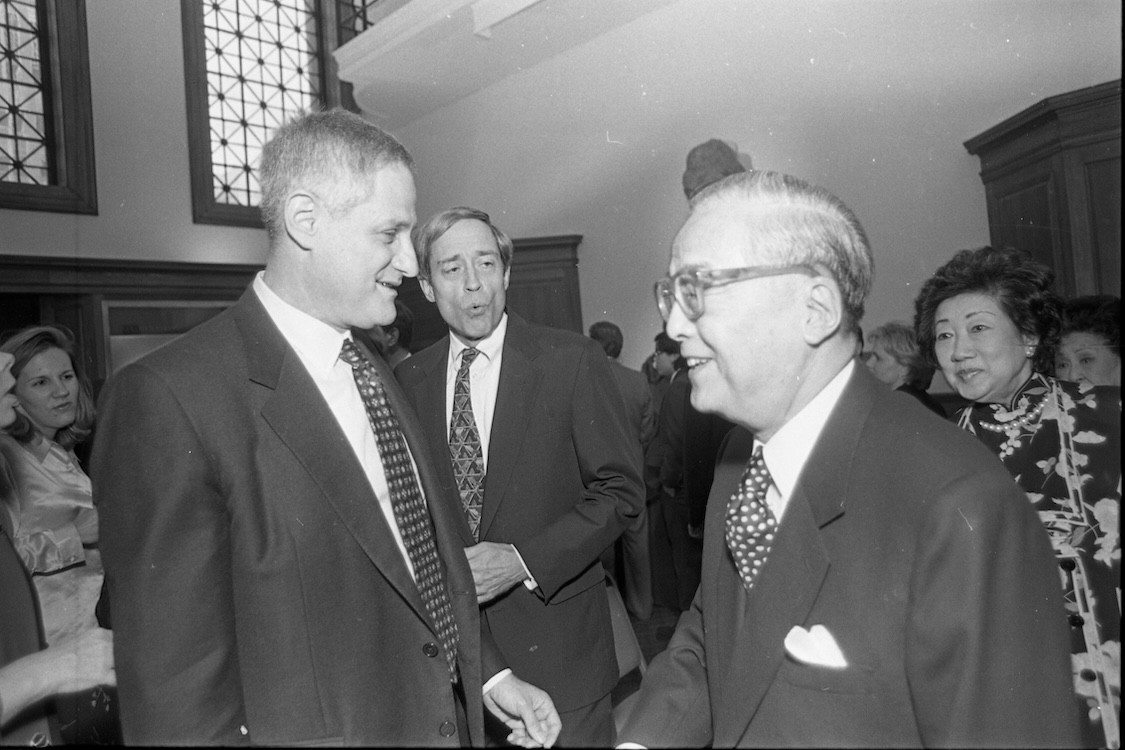 A black and white photo of Zvi Galil and Z.Y. Fu among a crowded room