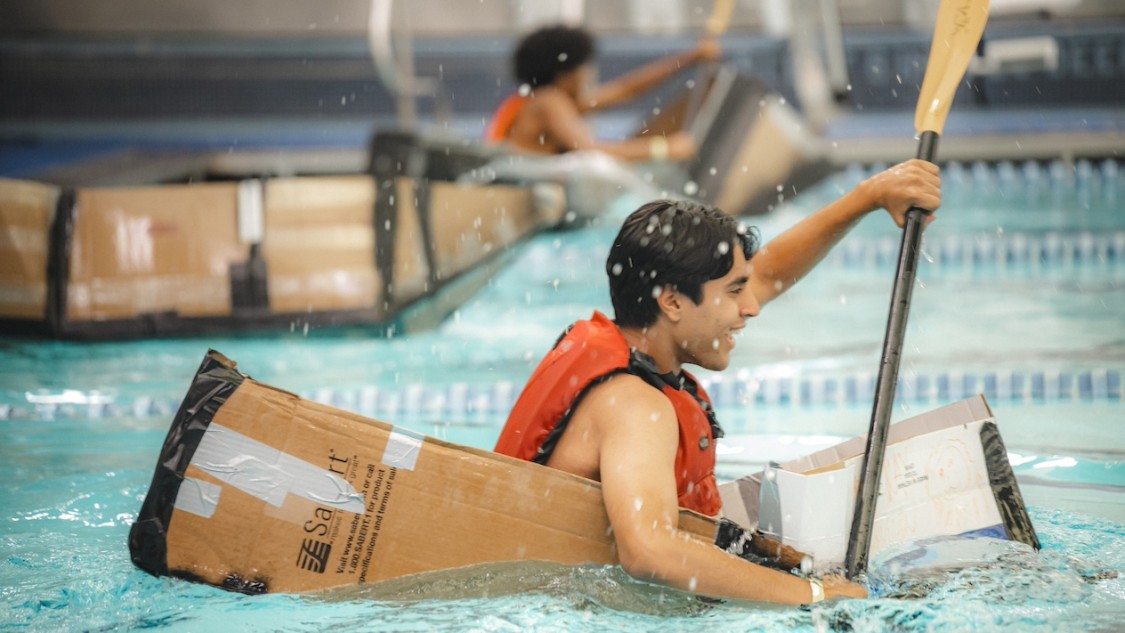 Students test out their cardboard creations in Uris Pool