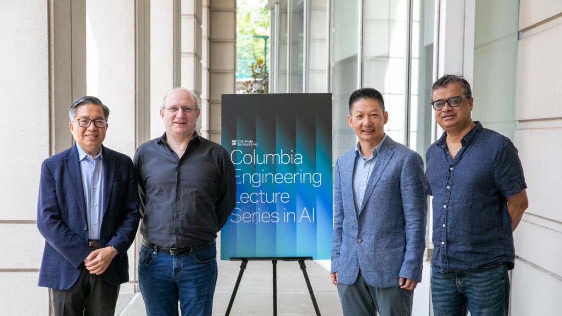 Dean Shih-Fu Chang, Kenneth Ross, Jun Rao and Vishal Misra standing beside a Columbia Engineering Lecture Series in AI sign after the event.