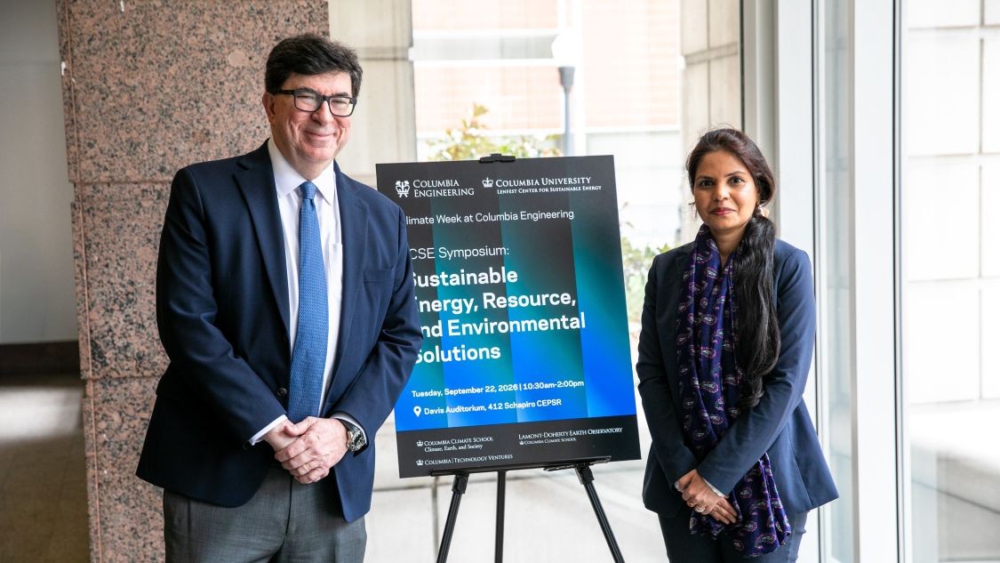 George Deodatis and Greeshma Gadikota pose beside an LCSE Symposium poster during Climate Week at Columbia Engineering.