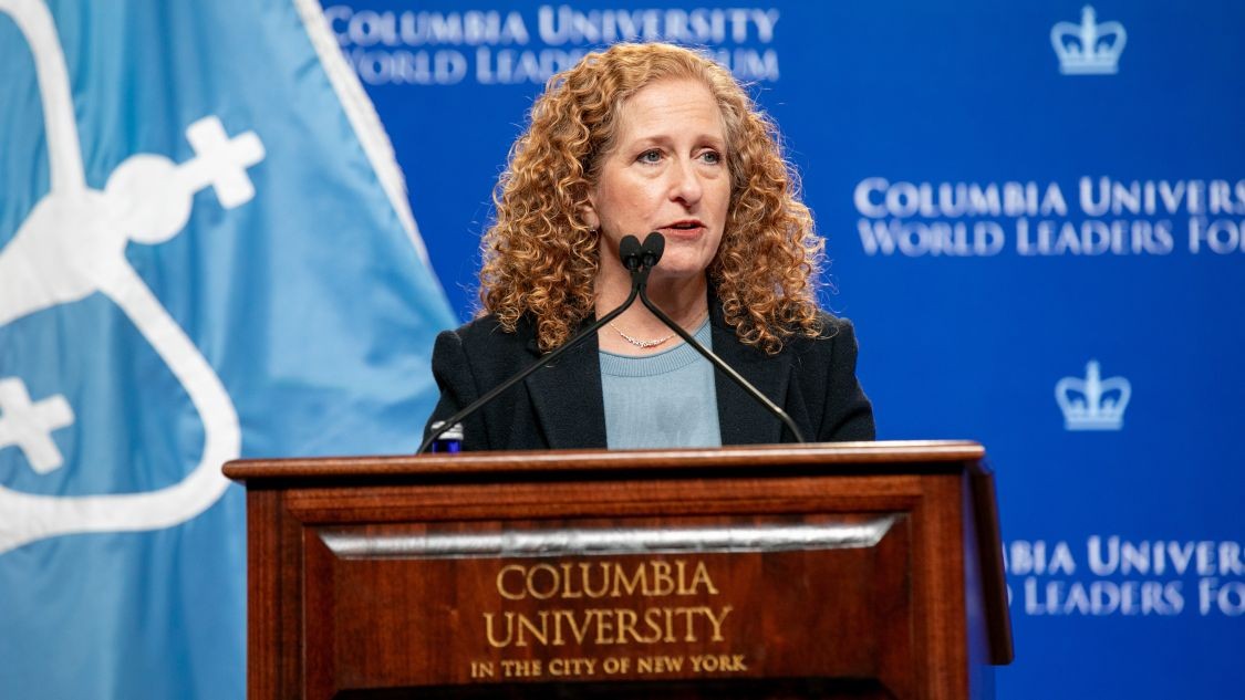 President Jennifer Mnookin gives opening remarks behind a Columbia University-branded podium at the Columbia University World Leaders Forum.