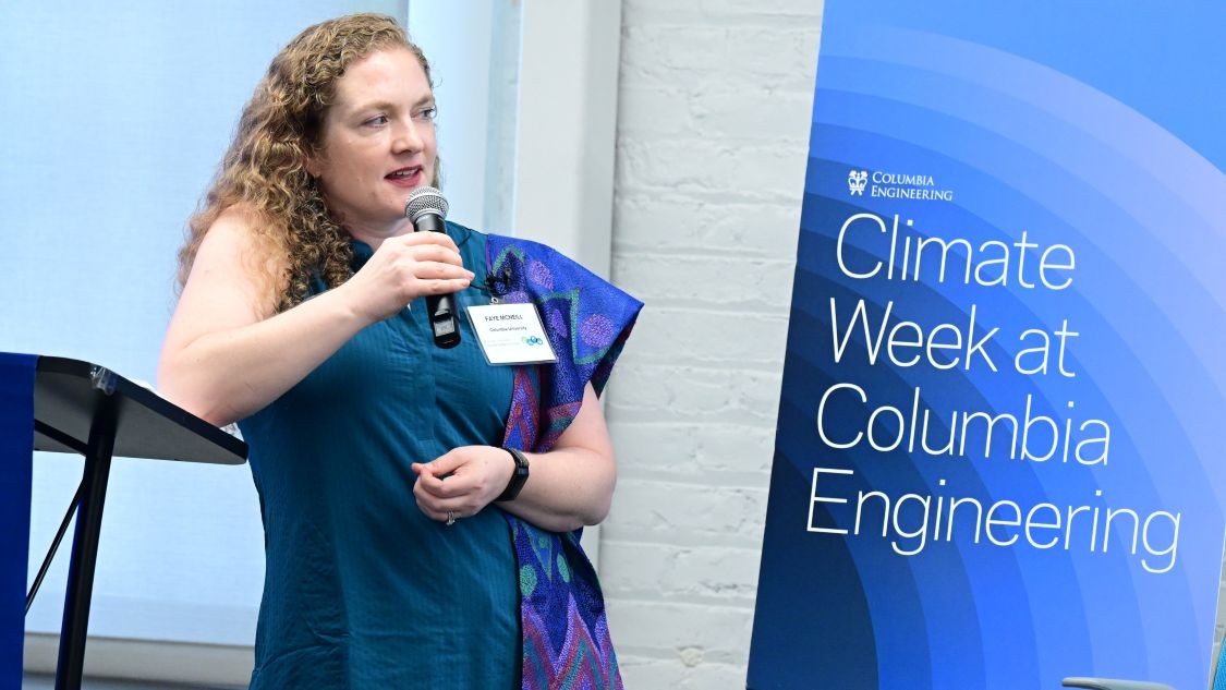 V. Faye McNeill speaks into a microphone beside a Climate Week at Columbia Engineering banner.