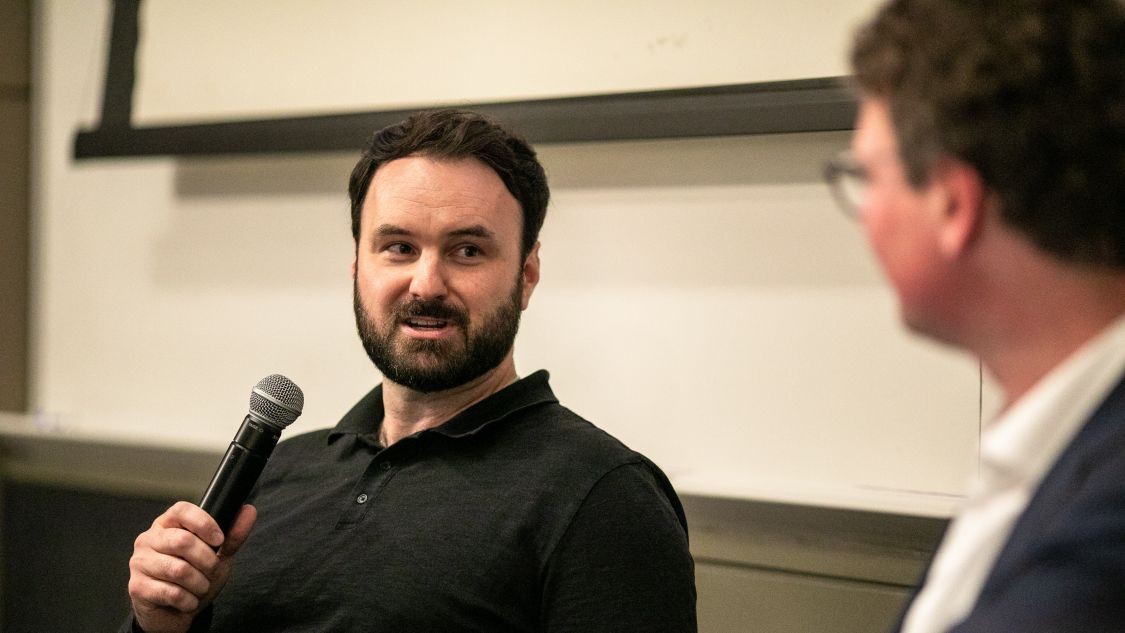 Wesley Pennington speaks into a microphone during a discussion at Columbia Engineering.