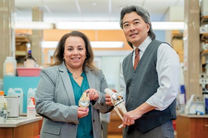 Nadeen O. Chahine and Clark Hung holding orthopedic models