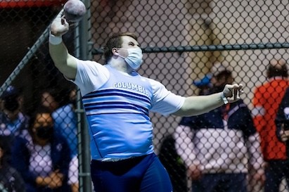 A Columbia University athlete throwing shot put