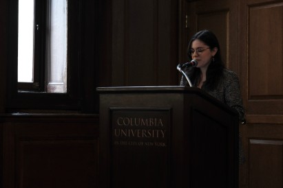 Ozgenur Celik speaking at a Columbia University podium
