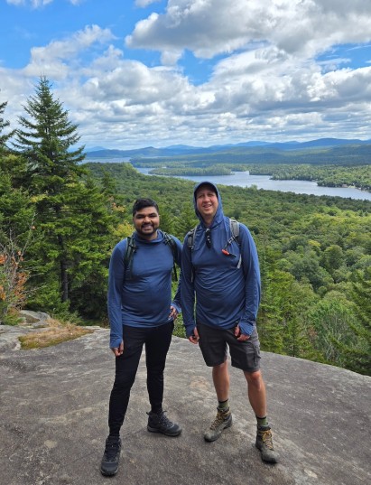 2 people posed for a photo on a hiking trail