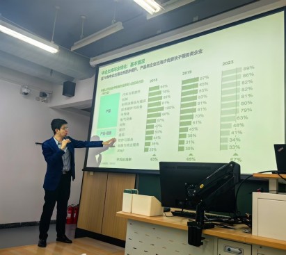 ziao yan pointing at a large presentation