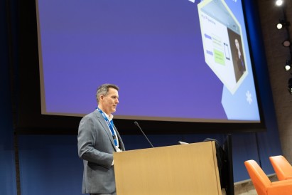 Andrew Smyth standing behind a podium on stage