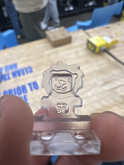 A resin-printed figurine of Columbia University mascot Roaree the lion held between someone's thumb and forefinger